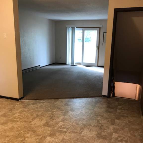 a room with a tiled floor and a sliding glass door.