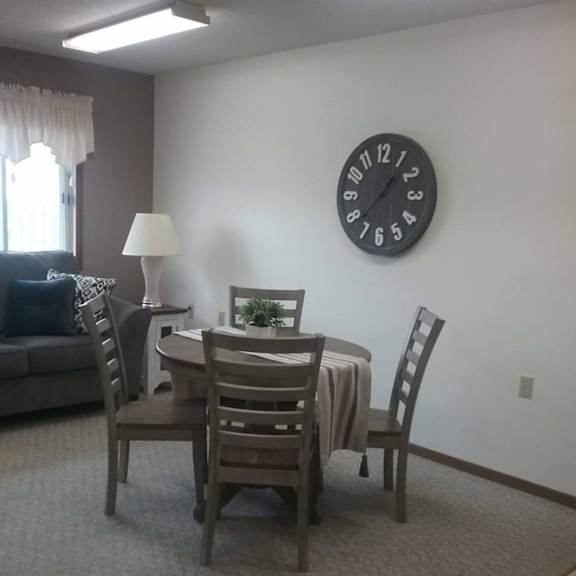 a dining room with a table set for four.