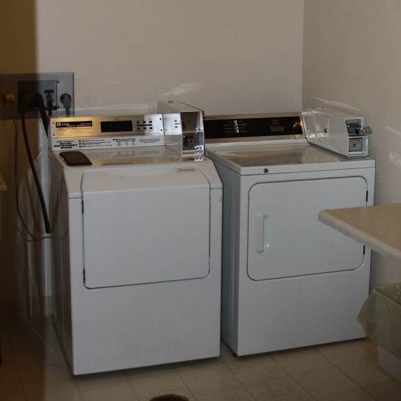 a white washing machine and dryer in a small room.