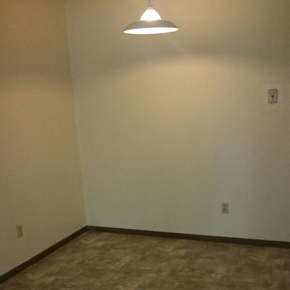 a room with a tiled floor and a light hanging from the ceiling.