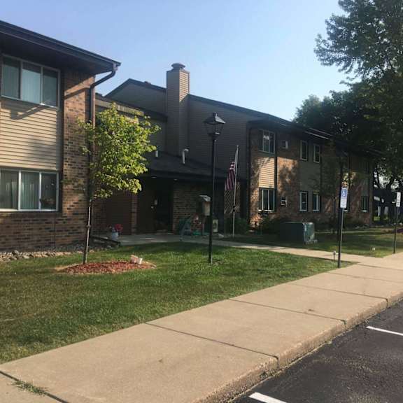 a residential area with a house and a parked car.