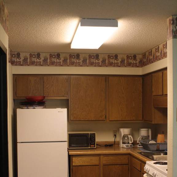 a kitchen with a white refrigerator and a white stove.
