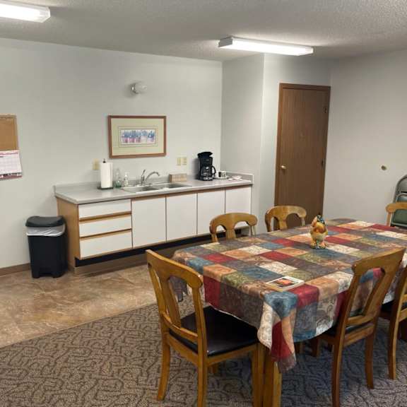 a kitchen area with a table and chairs.