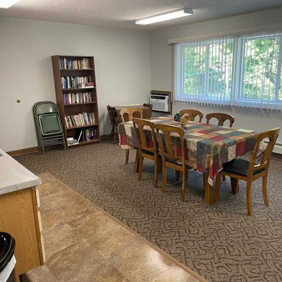 a kitchen with a table and chairs in the middle of the room.