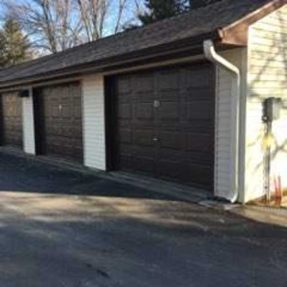 a long building with multiple garage doors.