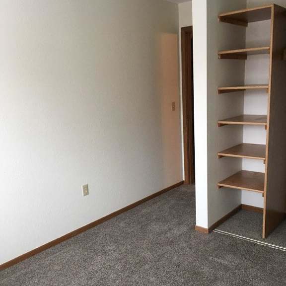 a room with a shelf and a carpet.