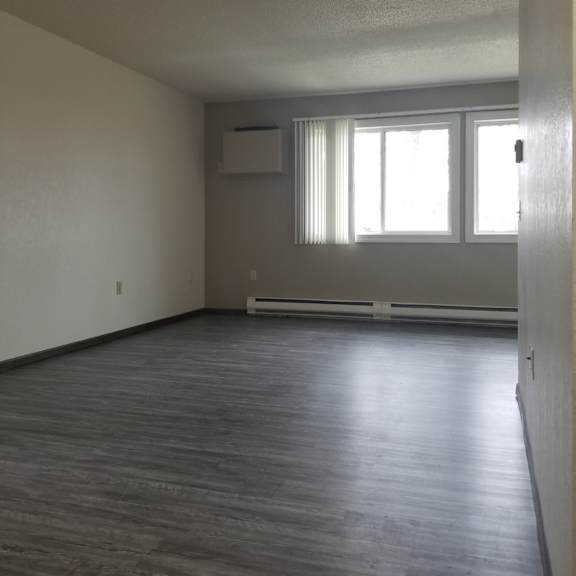 a room with a window and a radiator on the floor.