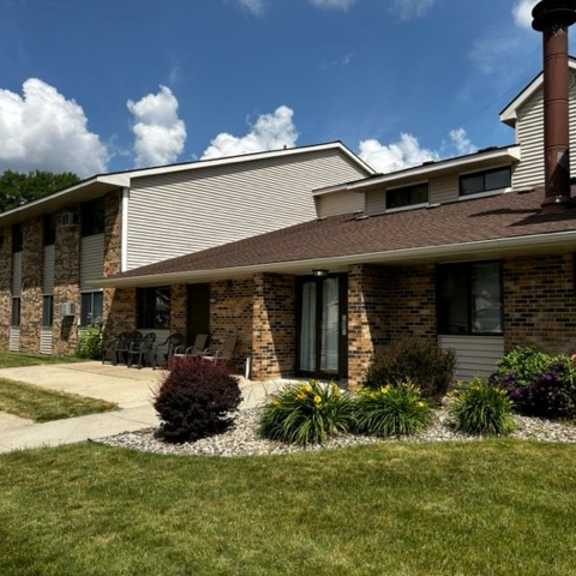 a house with a brown roof and a white garage door.