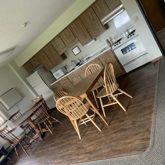 a kitchen with a table and chairs.