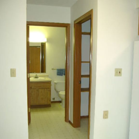 a bathroom with a sink, toilet and mirror.