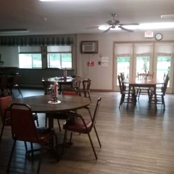 a dining room with a table and chairs.