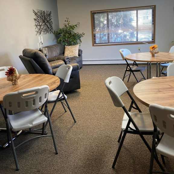 a room with a table and chairs in it.