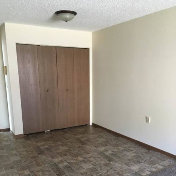 a room with a brown door and a tiled floor.