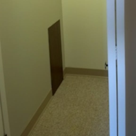 a hallway with a door on the right.
