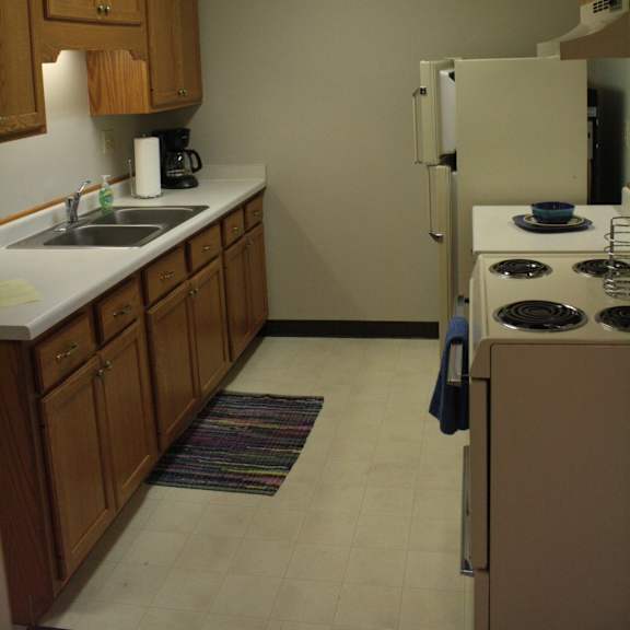a kitchen with a white fridge and a white stove.