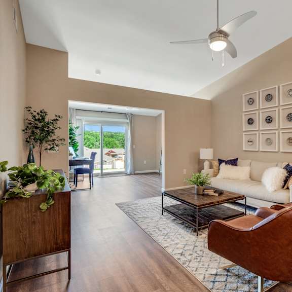 a living room with furniture and a ceiling fan