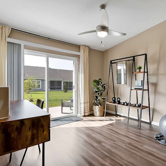 a living room with a mirror and a sliding glass door