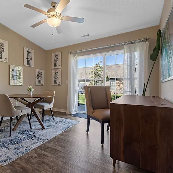 a dining room with a table and chairs.