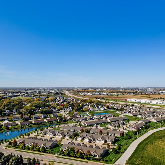 a suburban neighborhood with houses and a river.