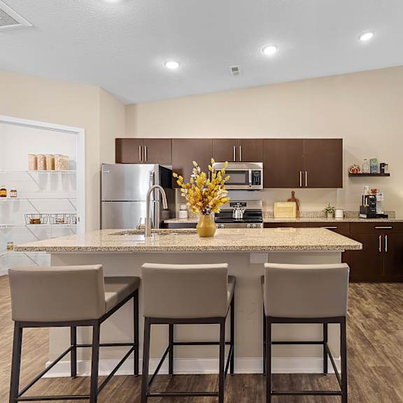 a modern kitchen with a dining table and chairs.