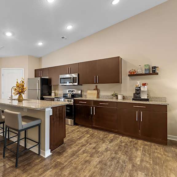 a kitchen with brown cabinets and a white island.