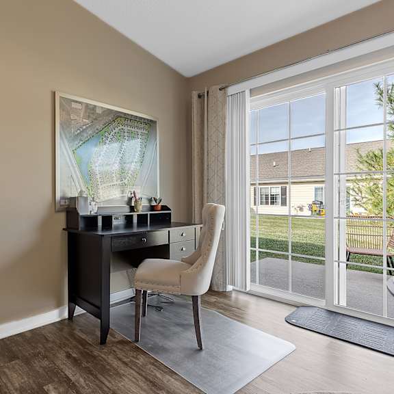 a room with a desk and chair in it.