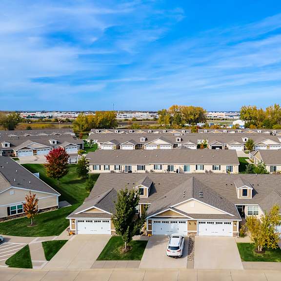 a suburban neighborhood with houses and cars.