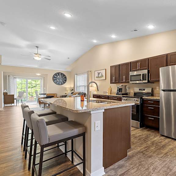 a kitchen with a refrigerator, microwave, and oven.