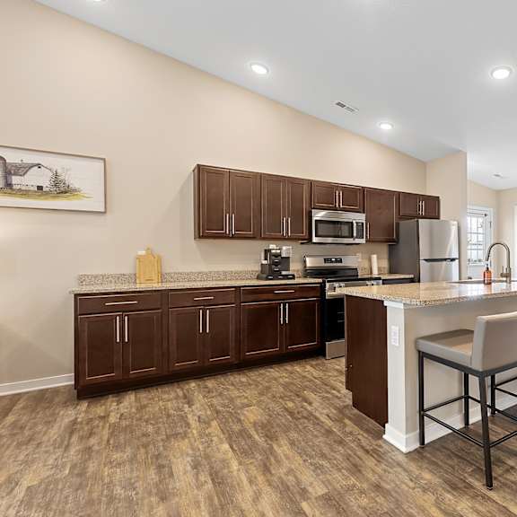 a kitchen with brown cabinets and a white island.
