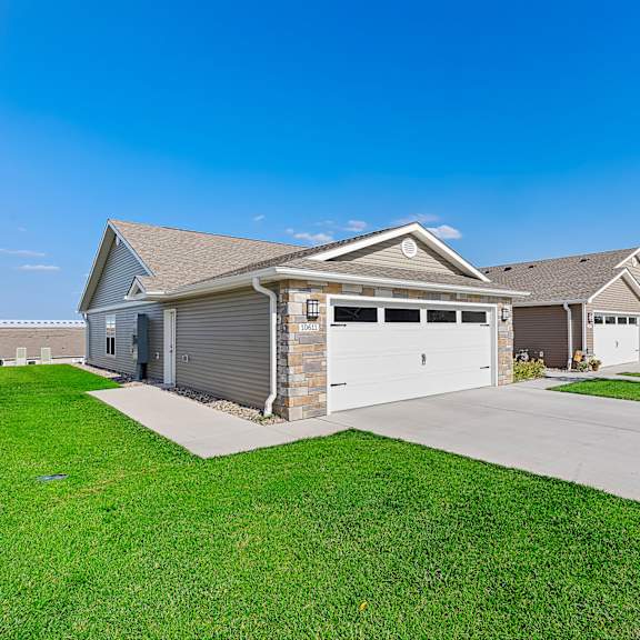 a large house with a garage and a driveway.