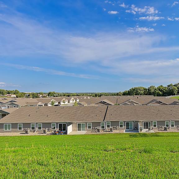 a large building with a green lawn in front of it.