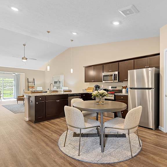 a modern kitchen with a dining table and chairs.