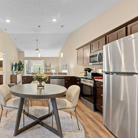 a kitchen with a table and chairs in the middle of the room.