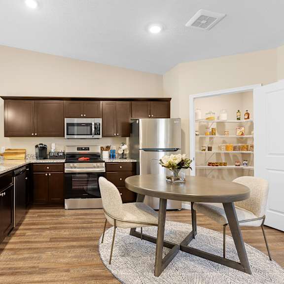 a modern kitchen with a table and chairs.