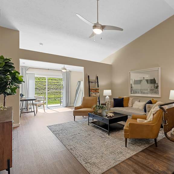 a living room with a couch, chairs, and a coffee table.