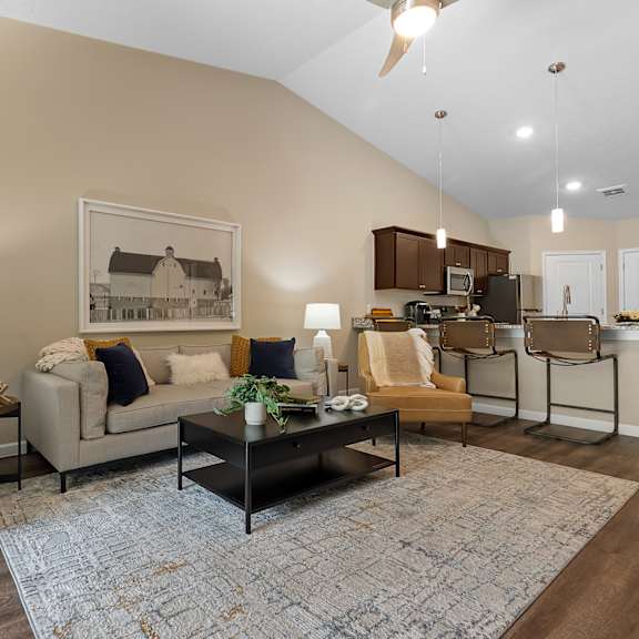 a living room with a couch, chairs, and a coffee table.