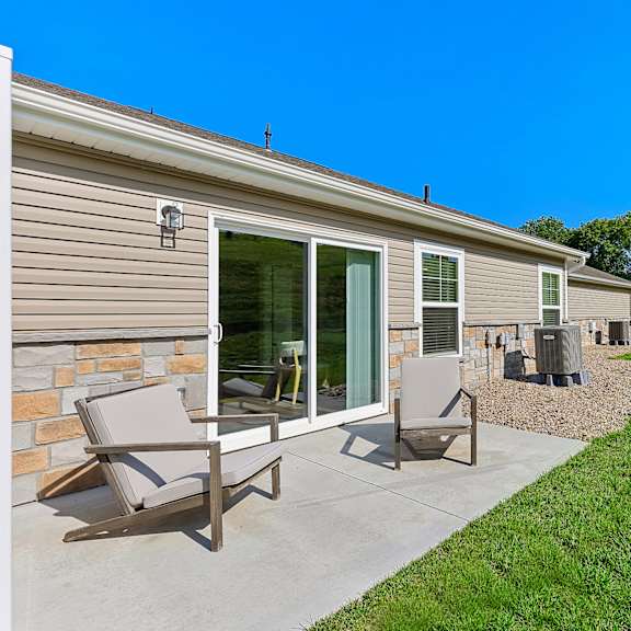 a house with a patio and lawn.
