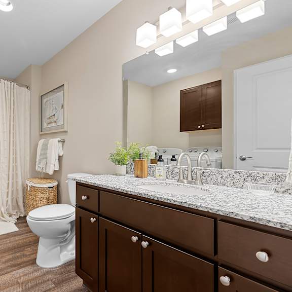 a bathroom with a toilet, sink, and bathtub.