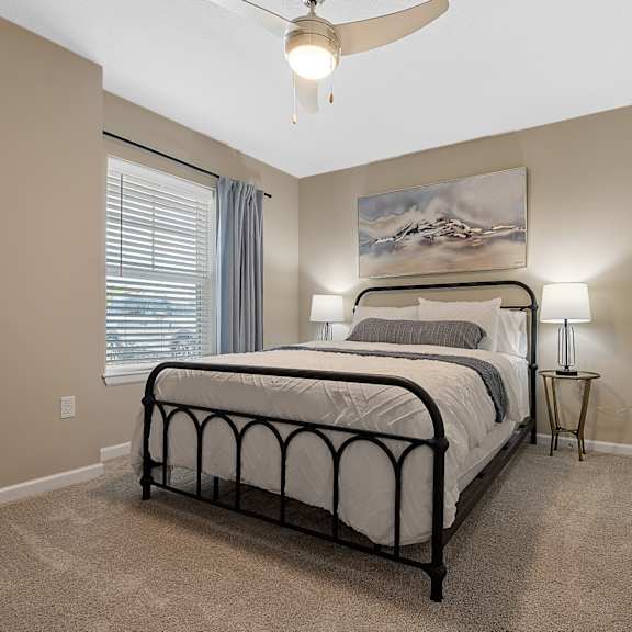 a bedroom with a large bed and a ceiling fan.