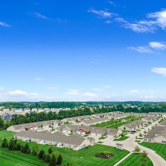 a large housing development with multiple houses and green lawns.