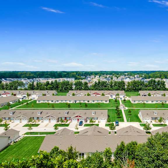 a bird's eye view of a residential neighborhood with houses and green lawns.