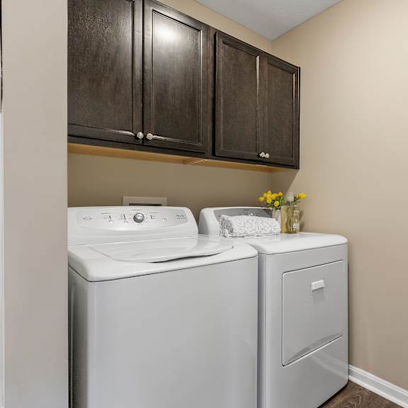 a white washing machine and dryer in a laundry room.