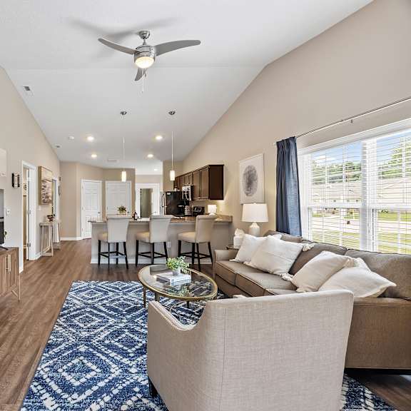 a living room with a television, couch, and chairs.