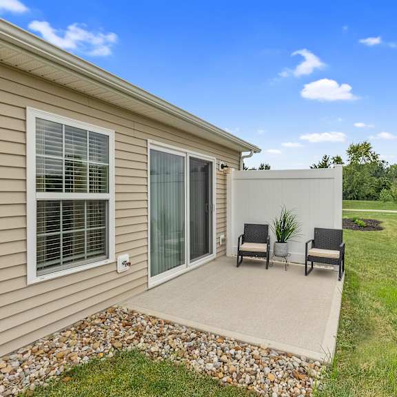 a house with a patio and a chair set.