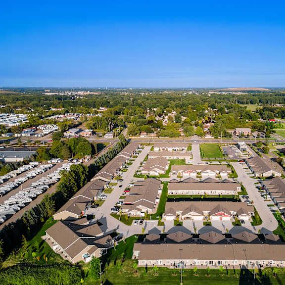 a bird's eye view of a residential area with houses and parked cars.