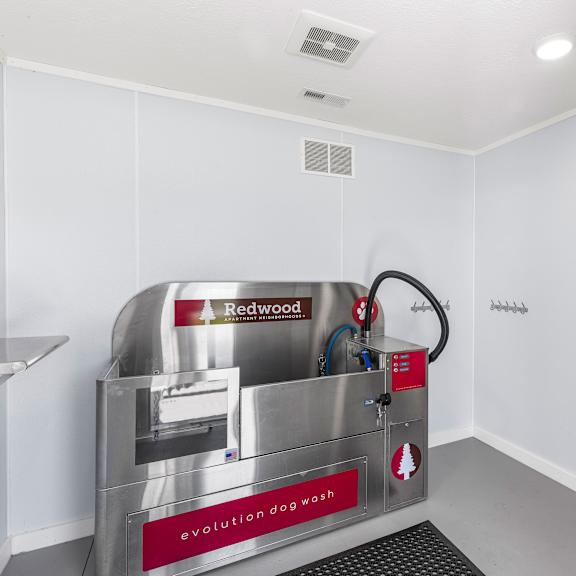 a redwood dog wash machine is in a white room.