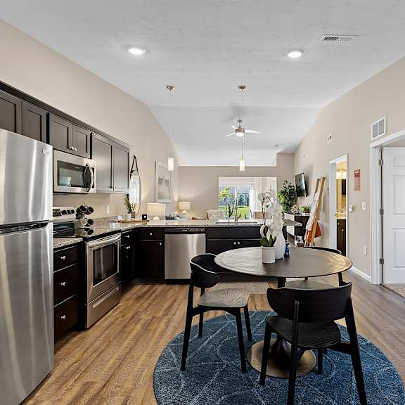 a modern kitchen with a dining table and chairs.