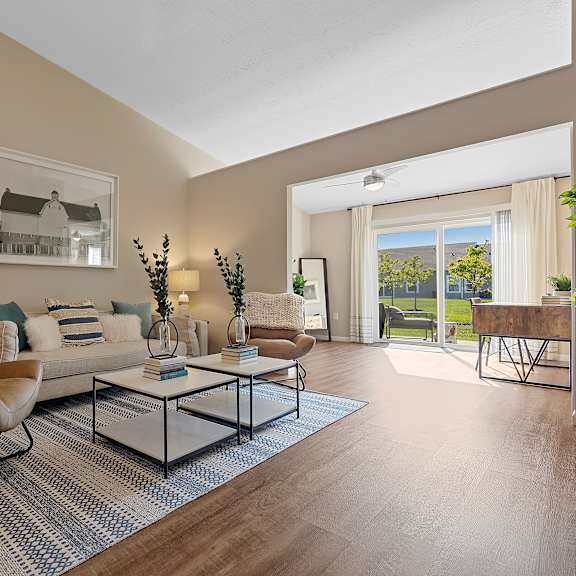 a living room with a brown leather chair and a glass coffee table.