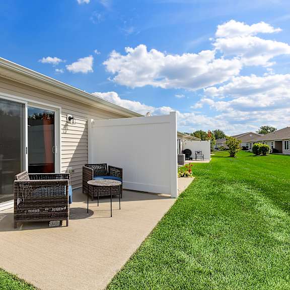 a house with a patio and a white wall.