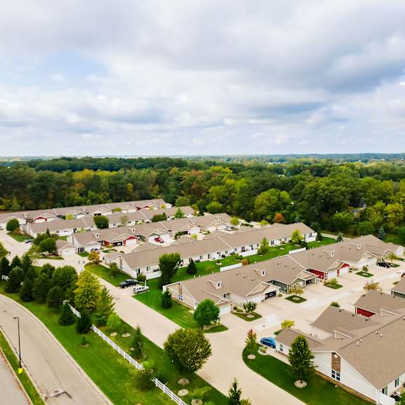 a bird's eye view of a residential area with houses and trees.